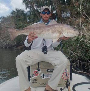 Captain Dustin Link Fly Fishing Redfish in Mosquito Lagoon Sittin On Yeti Cooler